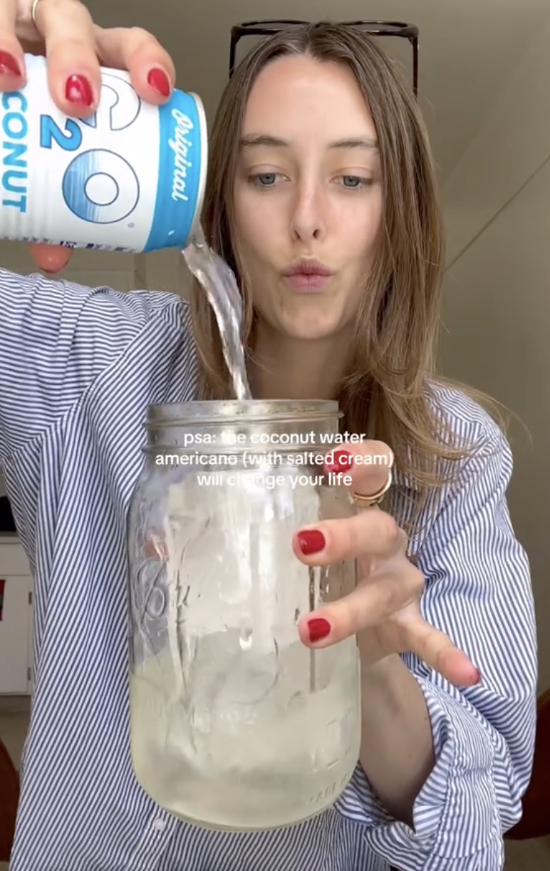 woman pouring water into a jar